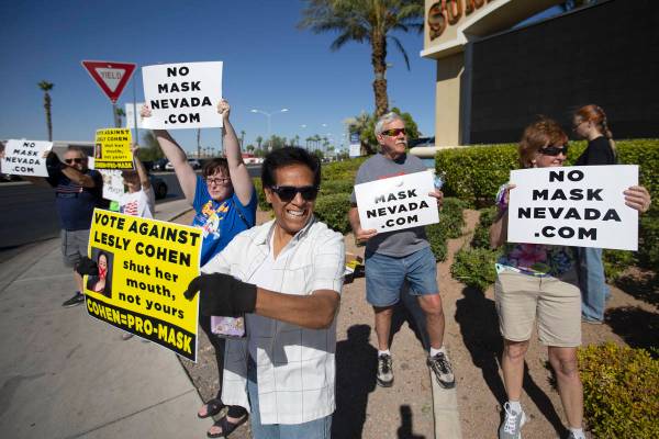 Jose Luis, of Las Vegas, participates in the "No Mask Protest" at the intersection of ...