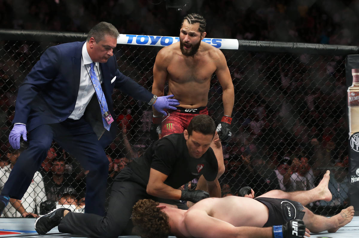 Jorge Masvidal, top, celebrates after knocking out Ben Askre in the first round during their we ...