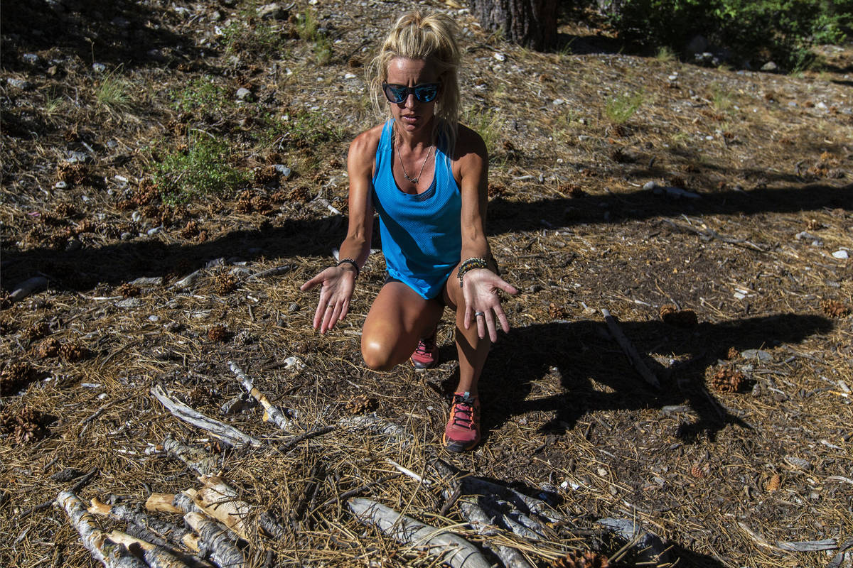 Stephanie Ibasco points out an illegal fire pit on a trail at Mount Charleston on Tuesday, July ...