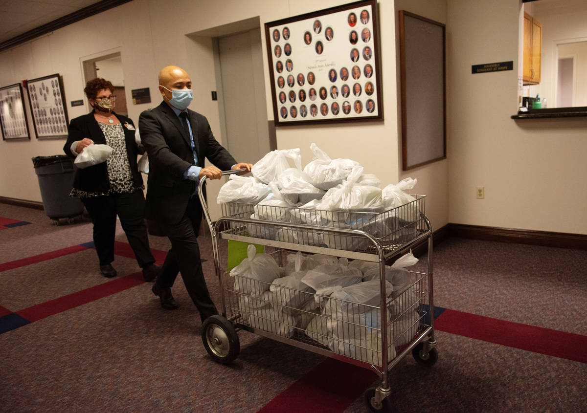 Assembly Sergeants at Arms bring lunch into he chambers on the second day of the 31st Special S ...