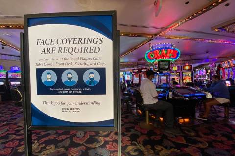 A sign notifying guests of face covering requirement at Four Queens in downtown Las Vegas on Fr ...