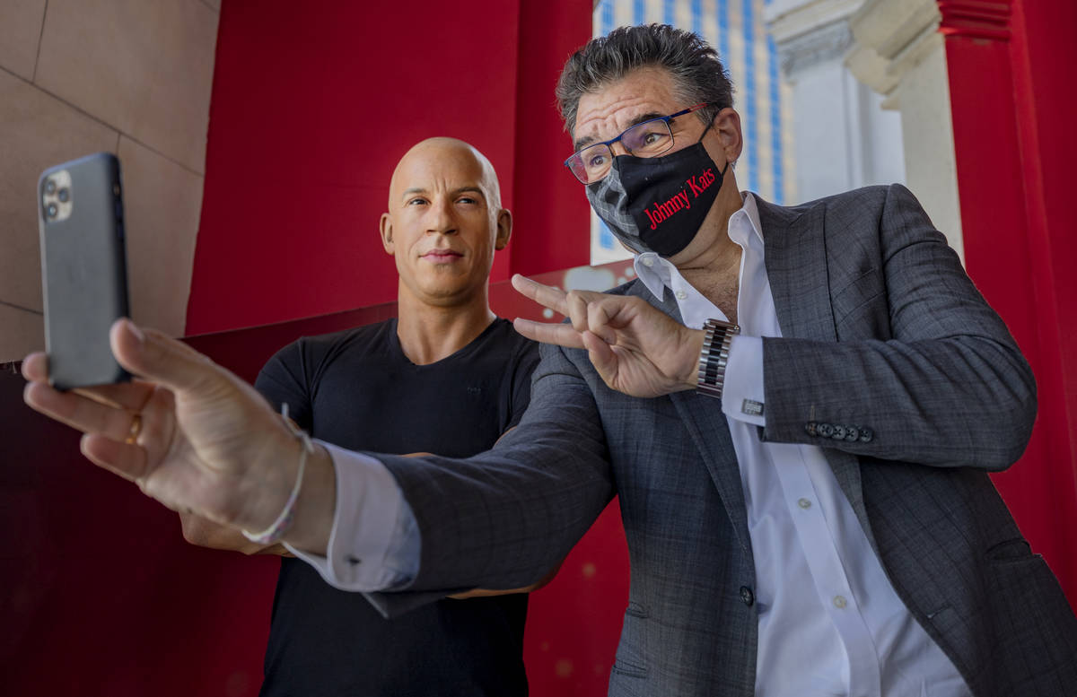 John Katsilometes takes a selfie with a wax figure of actor Vin Diesel in front of Madame Tussa ...