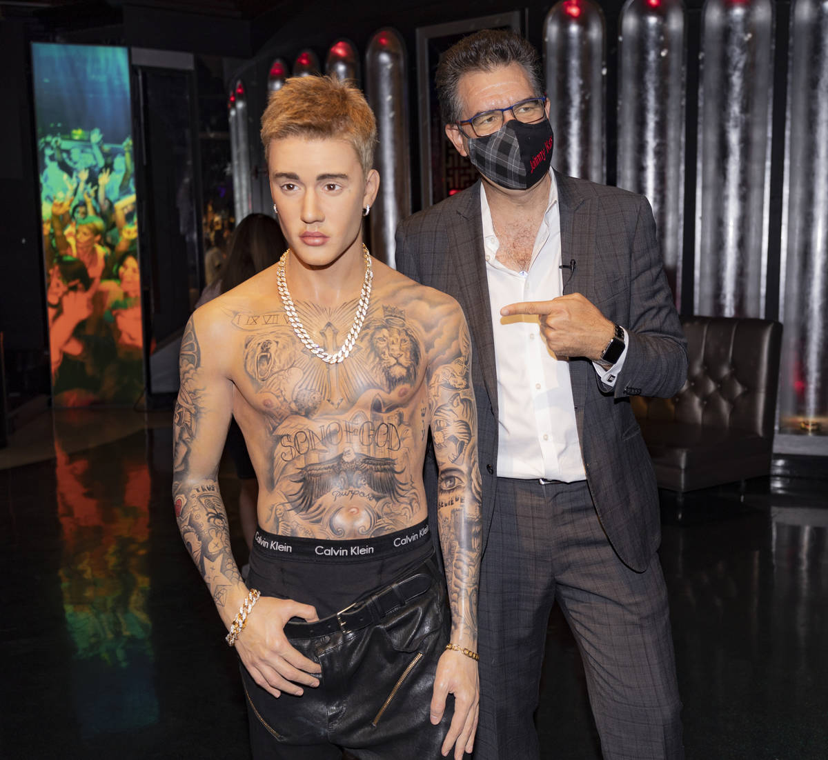 John Katsilometes is photographed with a wax figure of singer Justin Bieber during a tour of Ma ...