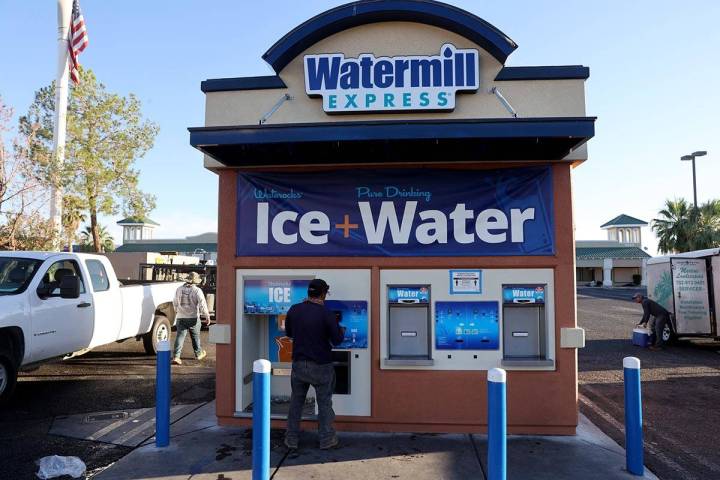 Pedro Hernandez gets ice for his work day at a kiosk on the corner of Smoke Ranch Road and Jone ...