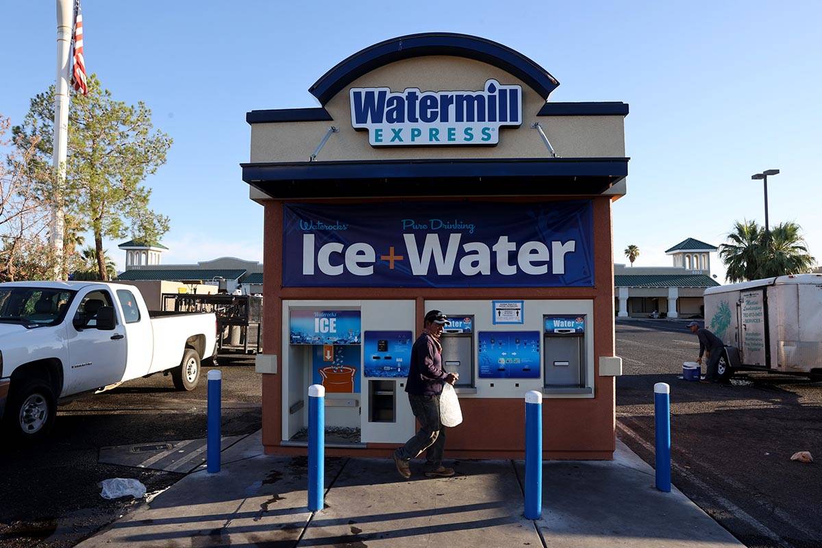 Pedro Hernandez gets ice for his work day at a kiosk on the corner of Smoke Ranch Road and Jone ...