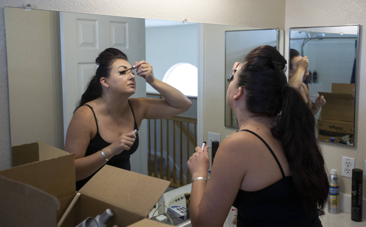 Alexis Cossman puts on makeup before her shift at Red Lobster on Tuesday, July 14, 2020, in Las ...