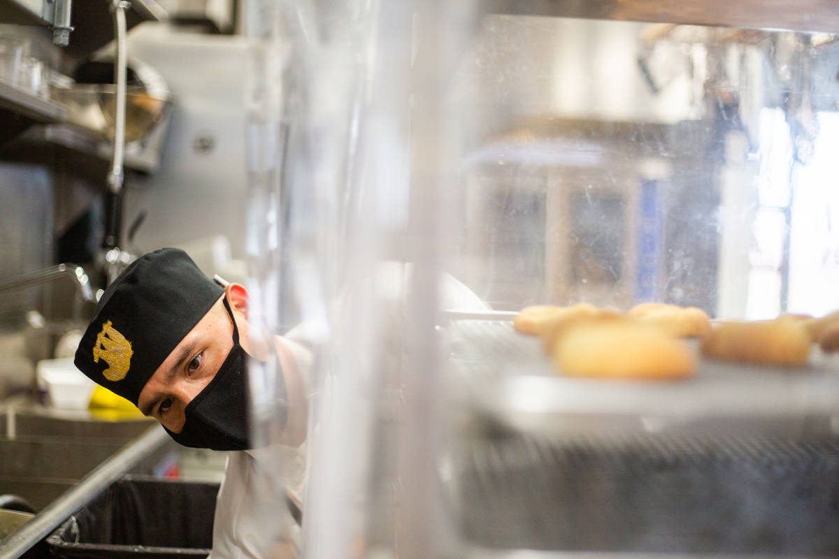Jorge Padilla, a pastry chef assistant, zips up a tray of bread at Take It Easy in Las Vegas on ...