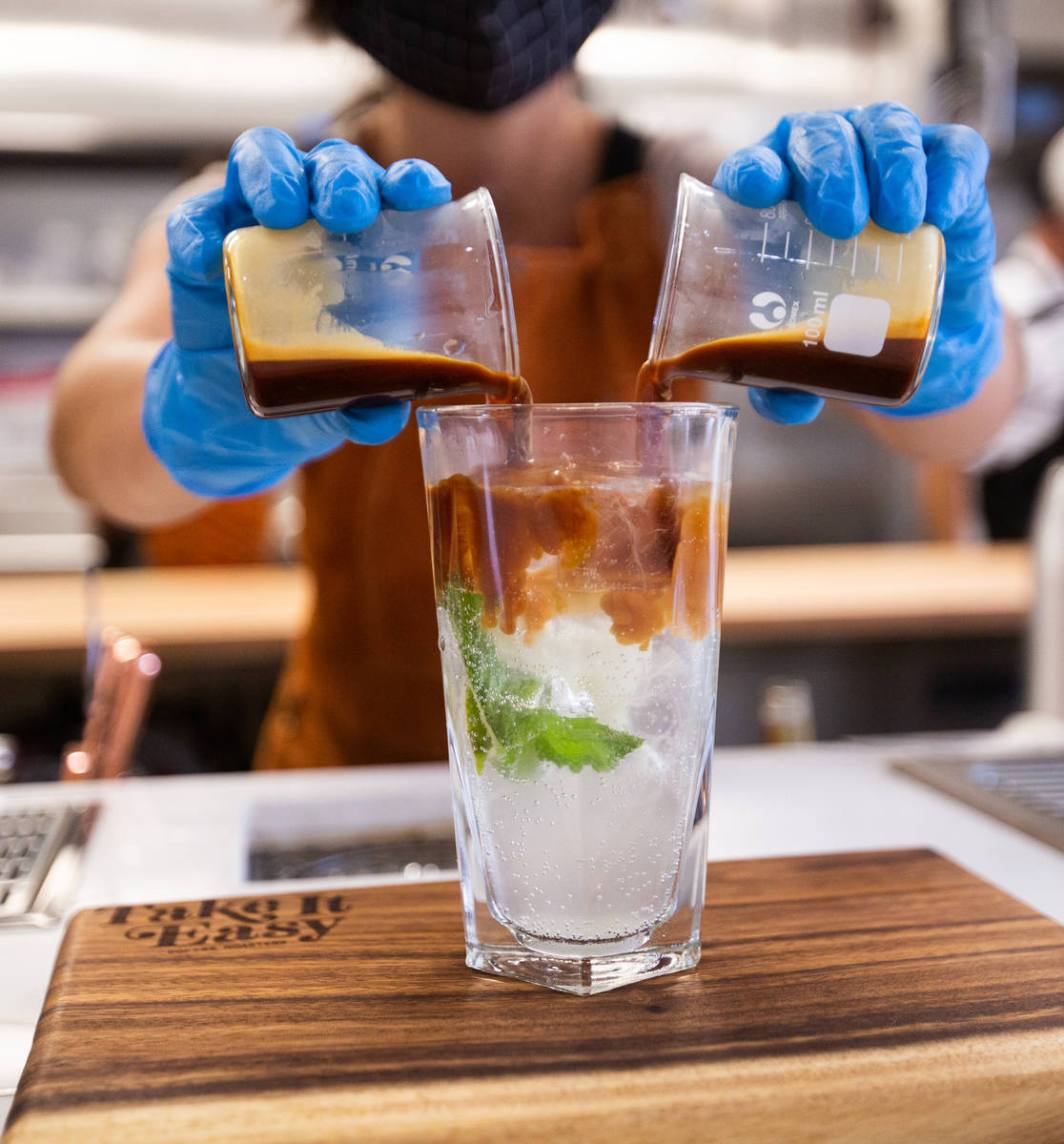 Quianna Rodriguez, a barista at Take It Easy, prepares the drink Somewhere in Kentucky in Las V ...