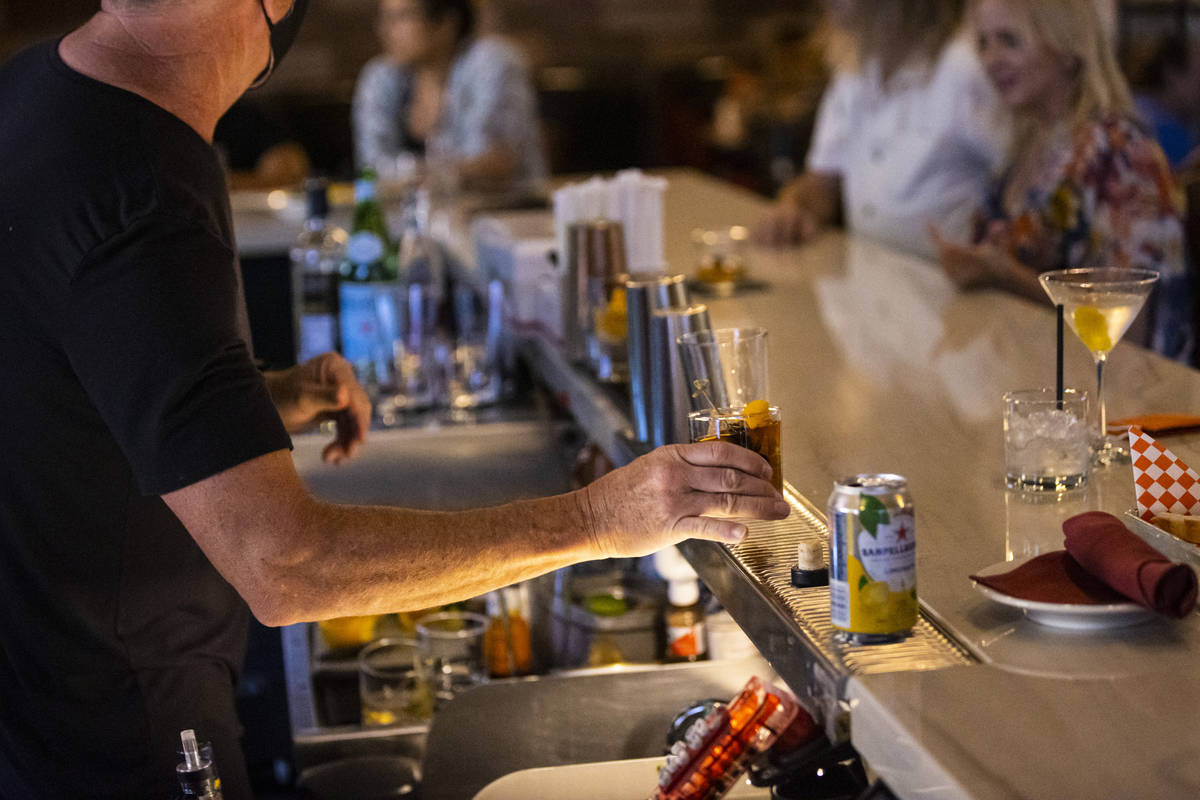 Bar manager David Cooper prepares a drink during happy hour at Spaghetty Western in the Souther ...