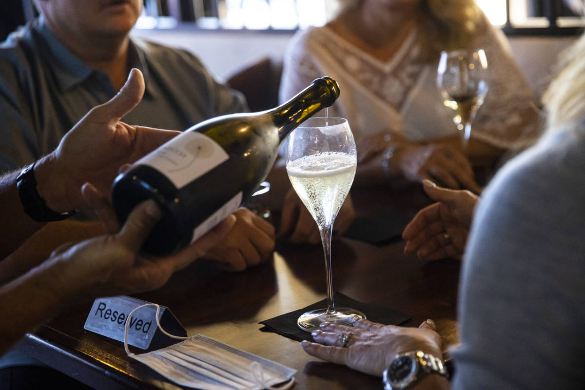 Bar manager David Cooper pours champagne during happy hour at Spaghetty Western in the Southern ...