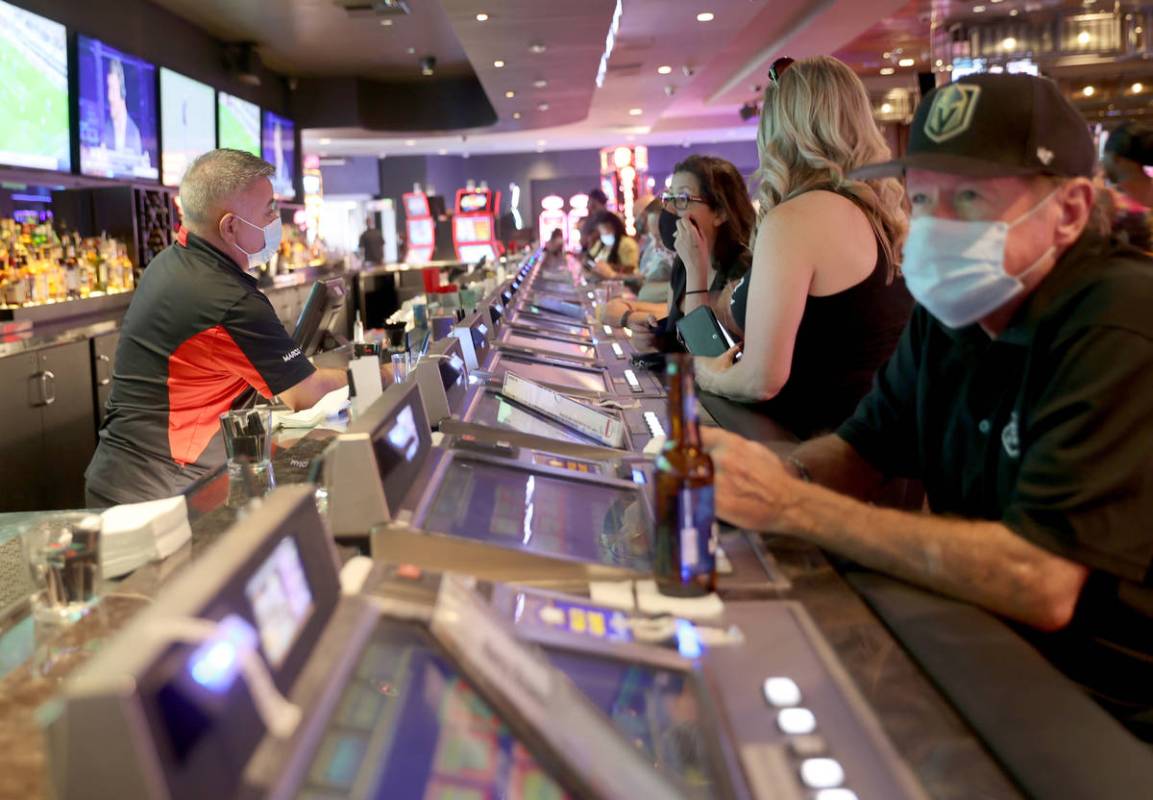 Ted Fager of Henderson, right, drinks at D Las Vegas, Friday, July 10, 2020, as Rosa Reyes, lef ...