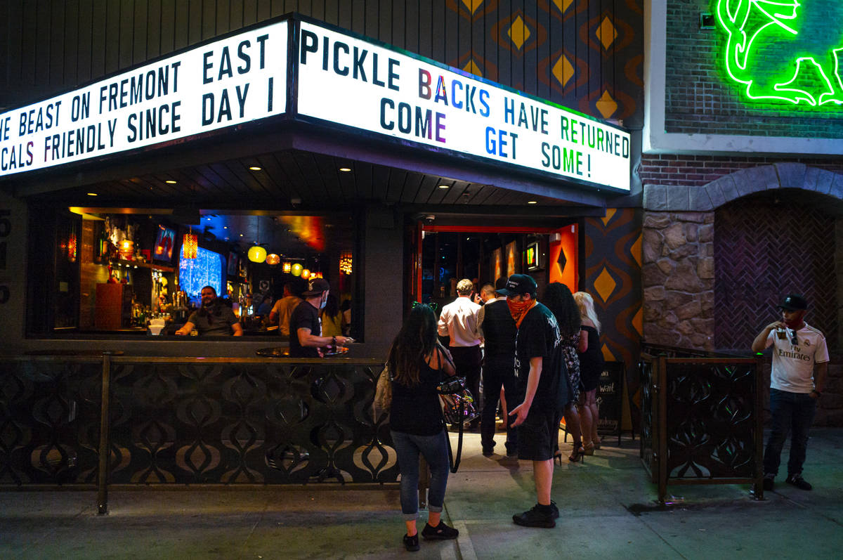 People line up at Cordury shortly before midnight on Fremont Street in downtown Las Vegas as ba ...