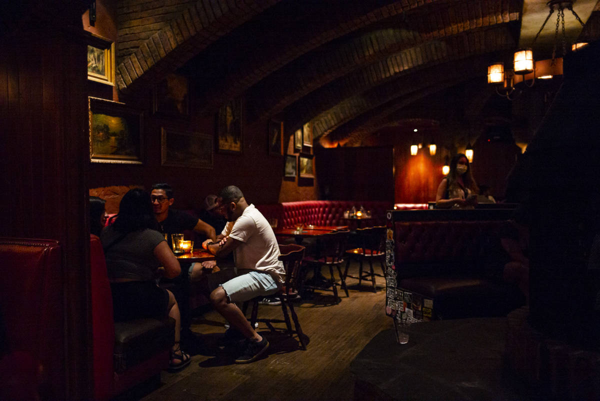 People drink just before last call at The Griffin on Fremont Street in downtown Las Vegas as ba ...