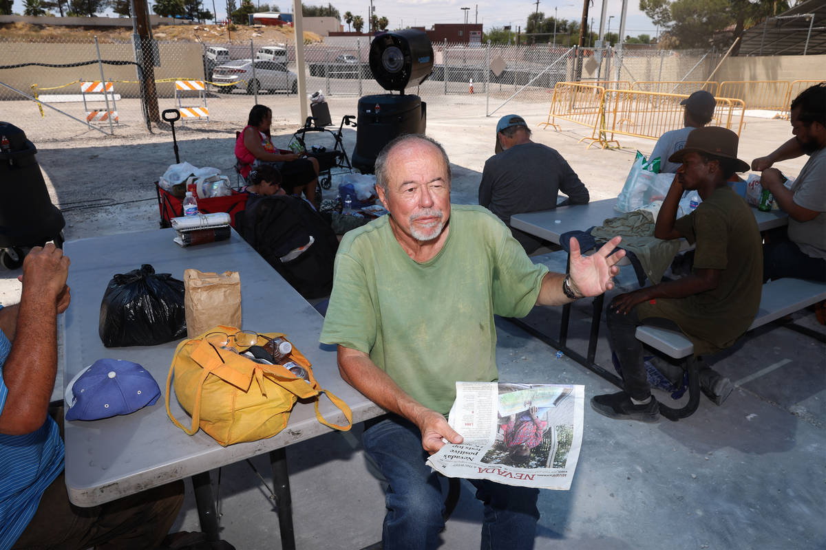 James Stamper reads thew newspaper under the shade at the Courtyard Homeless Resource Center co ...