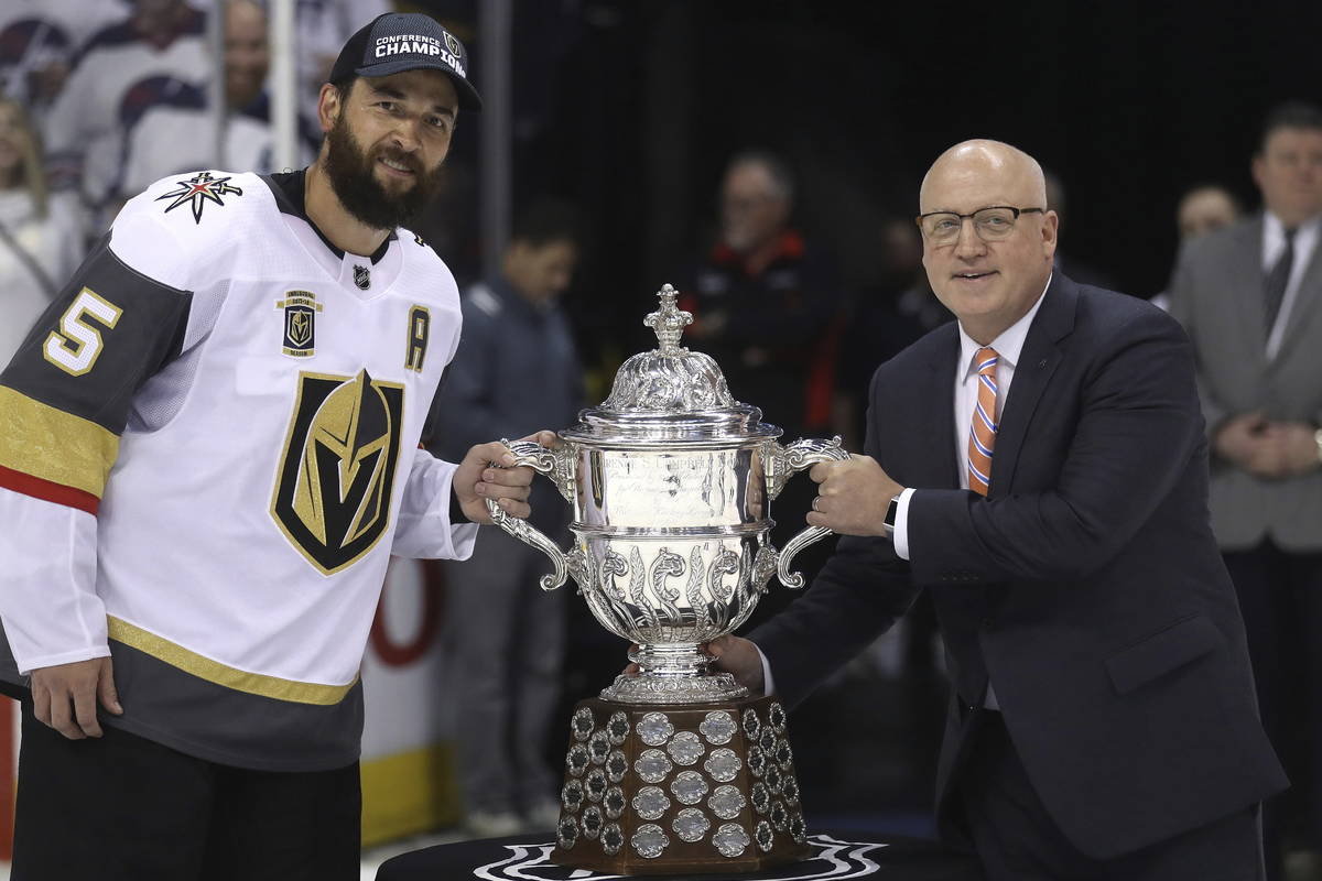 Vegas Golden Knights' Deryk Engelland (5) accepts the Clarence S. Campbell Bowl from Deputy Com ...