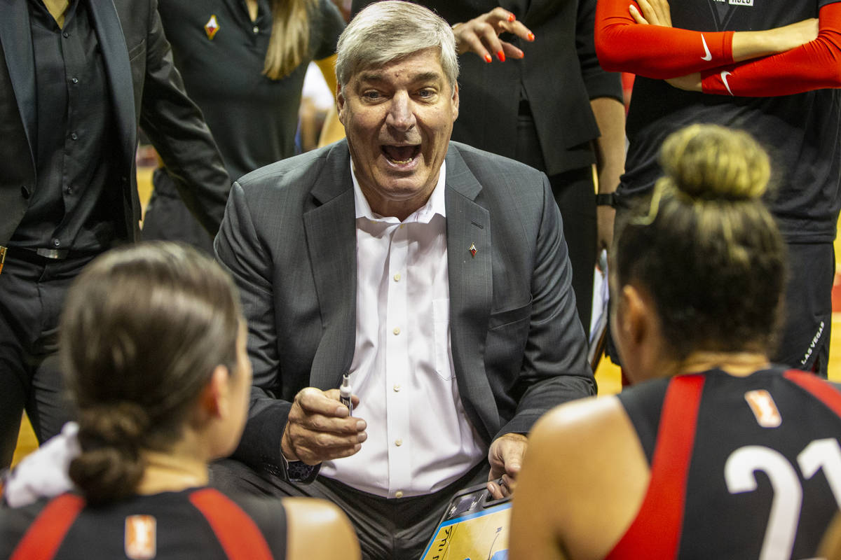 Las Vegas Aces head coach Bill Laimbeer talks up his players in a huddle during a timeout as th ...