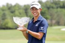 Collin Morikawa holds his trophy after winning the Workday Charity Open golf tournament, Sunday ...