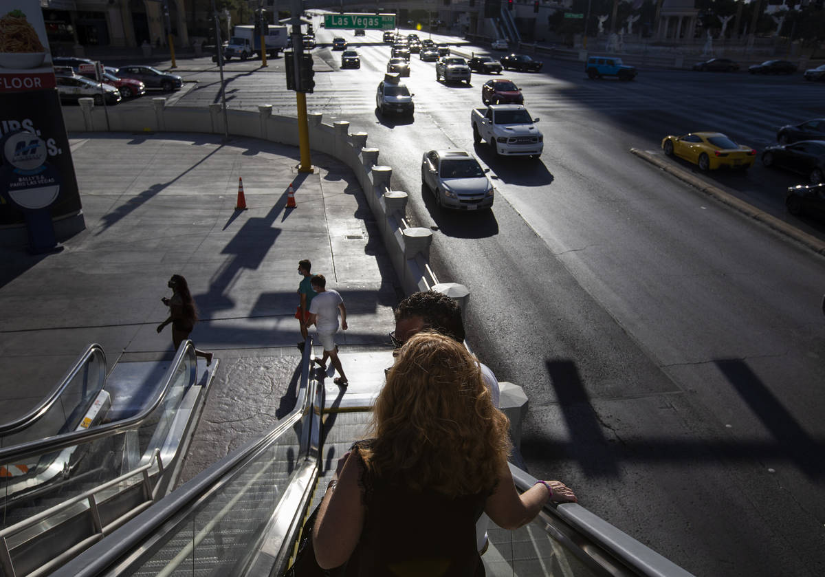The sun beats down on pedestrians as temperatures reached 113 degrees on Sunday, July 12, 2020, ...