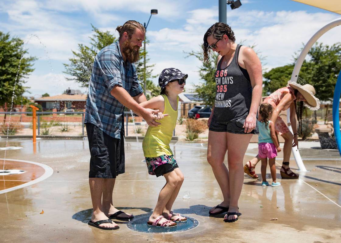 Kelly Luna, left, plays with his daughter Zowie Luna, 8, center, next to her mother Rebekah Und ...