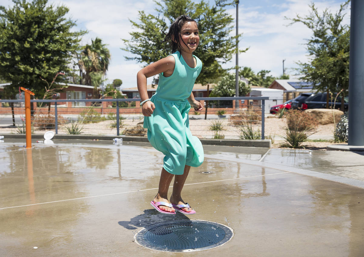 Myriah Vernoy, 8, plays in the water feature at Baker Park in Las Vegas, Sunday, July 12, 2020. ...