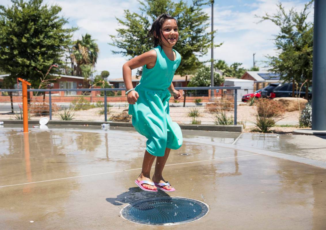 Myriah Vernoy, 8, plays in the water feature at Baker Park in Las Vegas, Sunday, July 12, 2020. ...