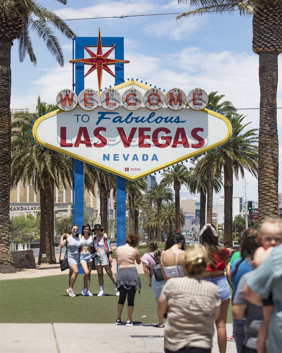 Visitors line up to take a photo at the Fabulous Las Vegas sign in Las Vegas, Sunday, July 12, ...