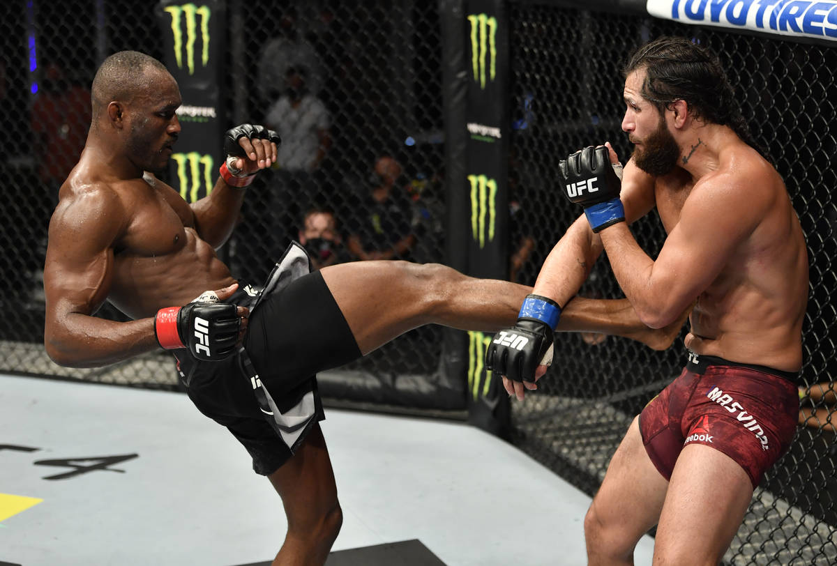 (L-R) Kamaru Usman of Nigeria kicks Jorge Masvidal in their UFC welterweight championship fight ...