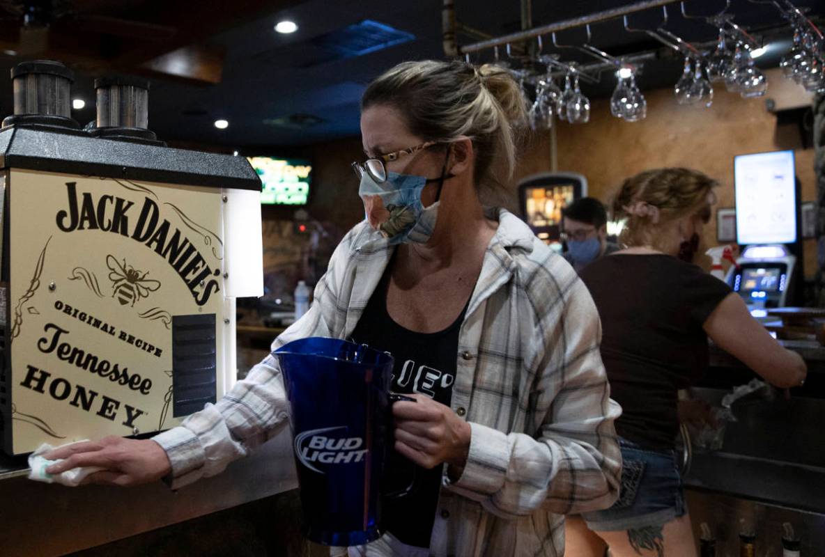 Bartender Dawn Smith wipes down the bar after last call at Jacksonճ Bar & Grill on Fr ...