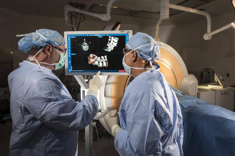 Certified surgical technicians Jay French, left, and Rodney Haynes examine mock 3-D images take ...