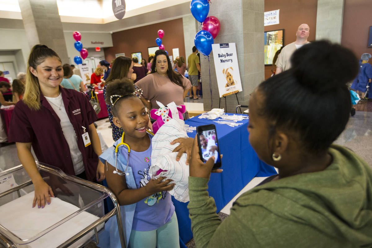 Kynnidi Graham Bryant, 9, shows off her teddy bear to mother Ciera Graham during the Teddy Bear ...