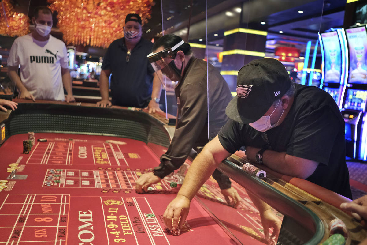 Craps players and dealers are seperated by partitions at the Golden Nugget Casino in Atlantic C ...