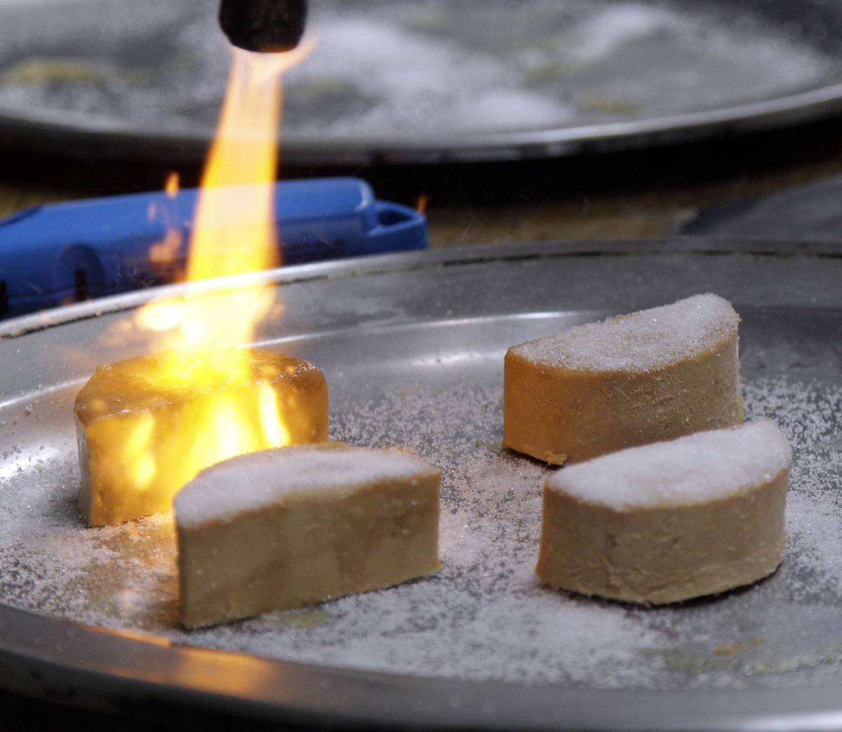 FILE - In this Friday, May 11, 2012, file photo, Foie Gras is torched and made into a Brulee at ...