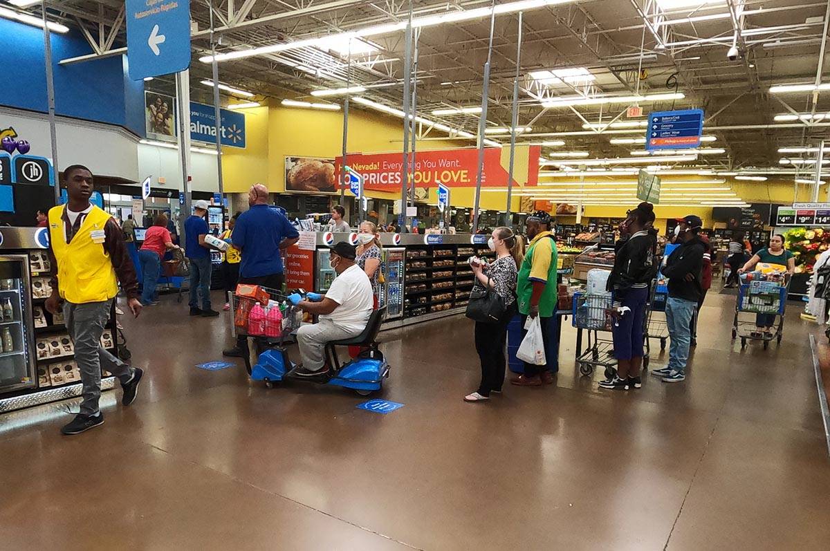 People line up to pay at the Walmart Supercenter, 3950 W Lake Mead Blvd. in North Las Vegas, Sa ...