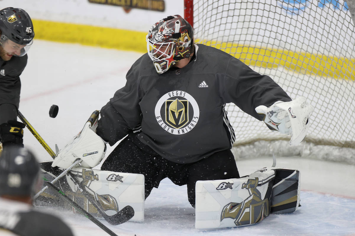 Vegas Golden Knights goaltender Robin Lehner (90) makes a stop as teammate Jake Bischoff (45) l ...