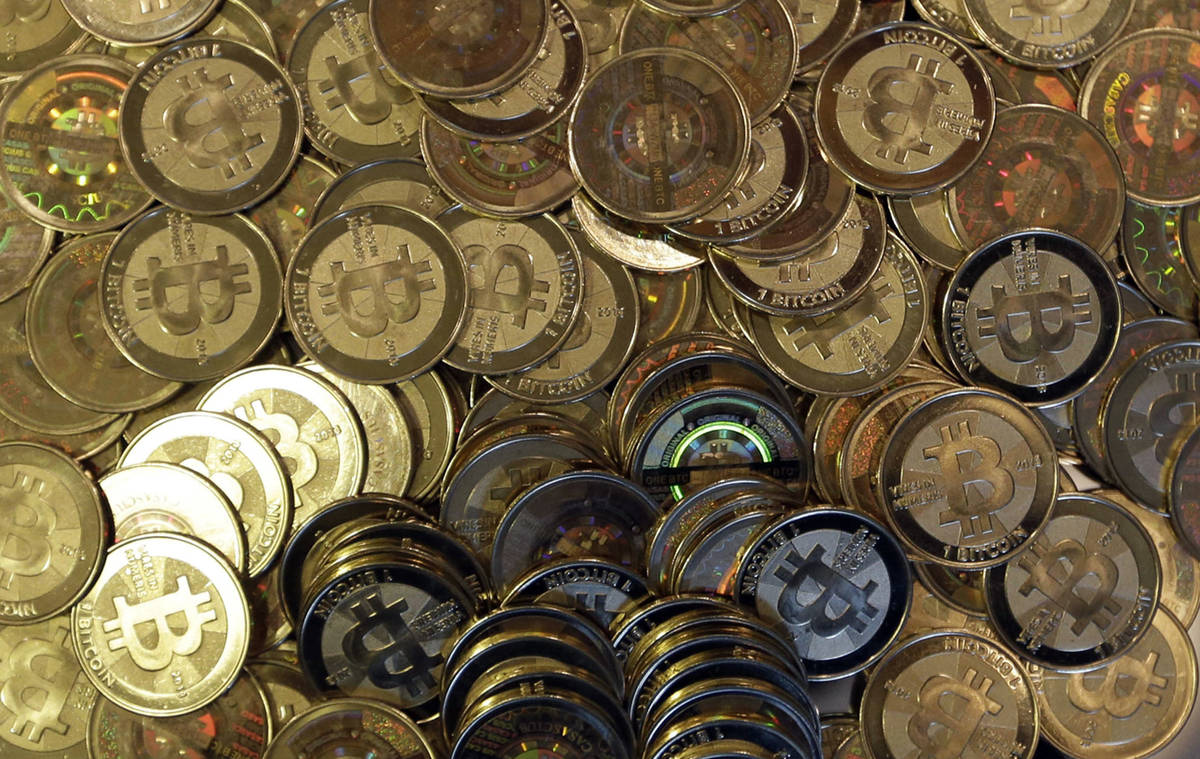 FILE - This April 3, 2013, file photo shows bitcoin tokens in Sandy, Utah. Unidentified hackers ...