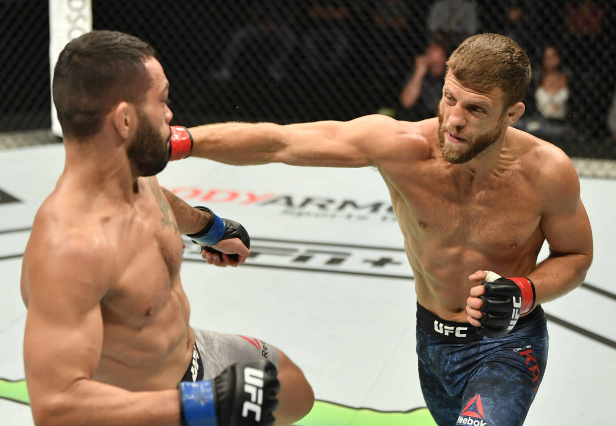 (R-L) Calvin Kattar punches Dan Ige in their featherweight fight during the UFC Fight Night eve ...