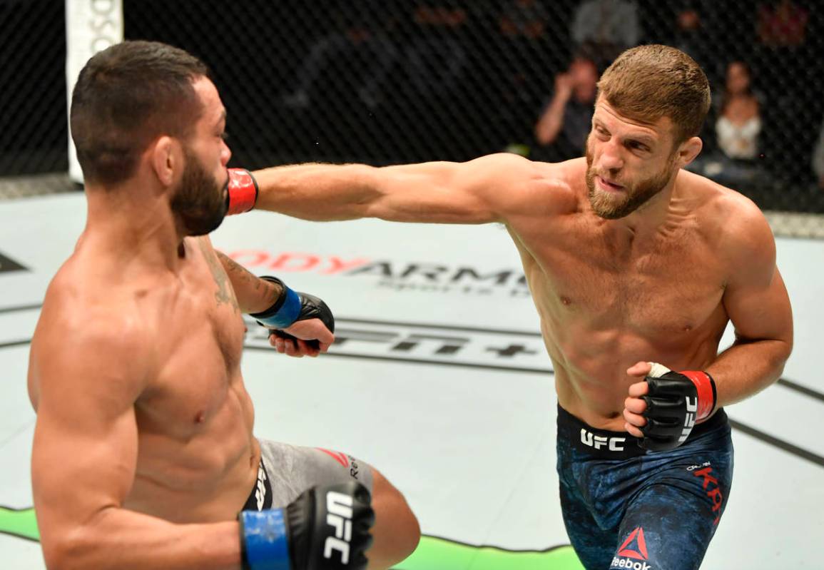 (R-L) Calvin Kattar punches Dan Ige in their featherweight fight during the UFC Fight Night eve ...