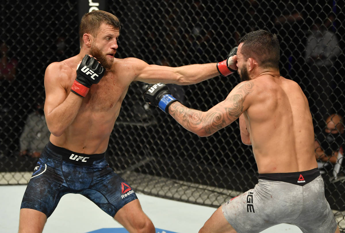 (L-R) Calvin Kattar punches Dan Ige in their featherweight fight during the UFC Fight Night eve ...