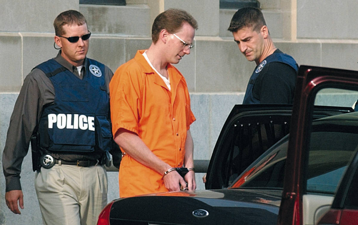 In this Aug. 18, 2004, file photo, Dustin Honken is led by federal marshals to a waiting car af ...
