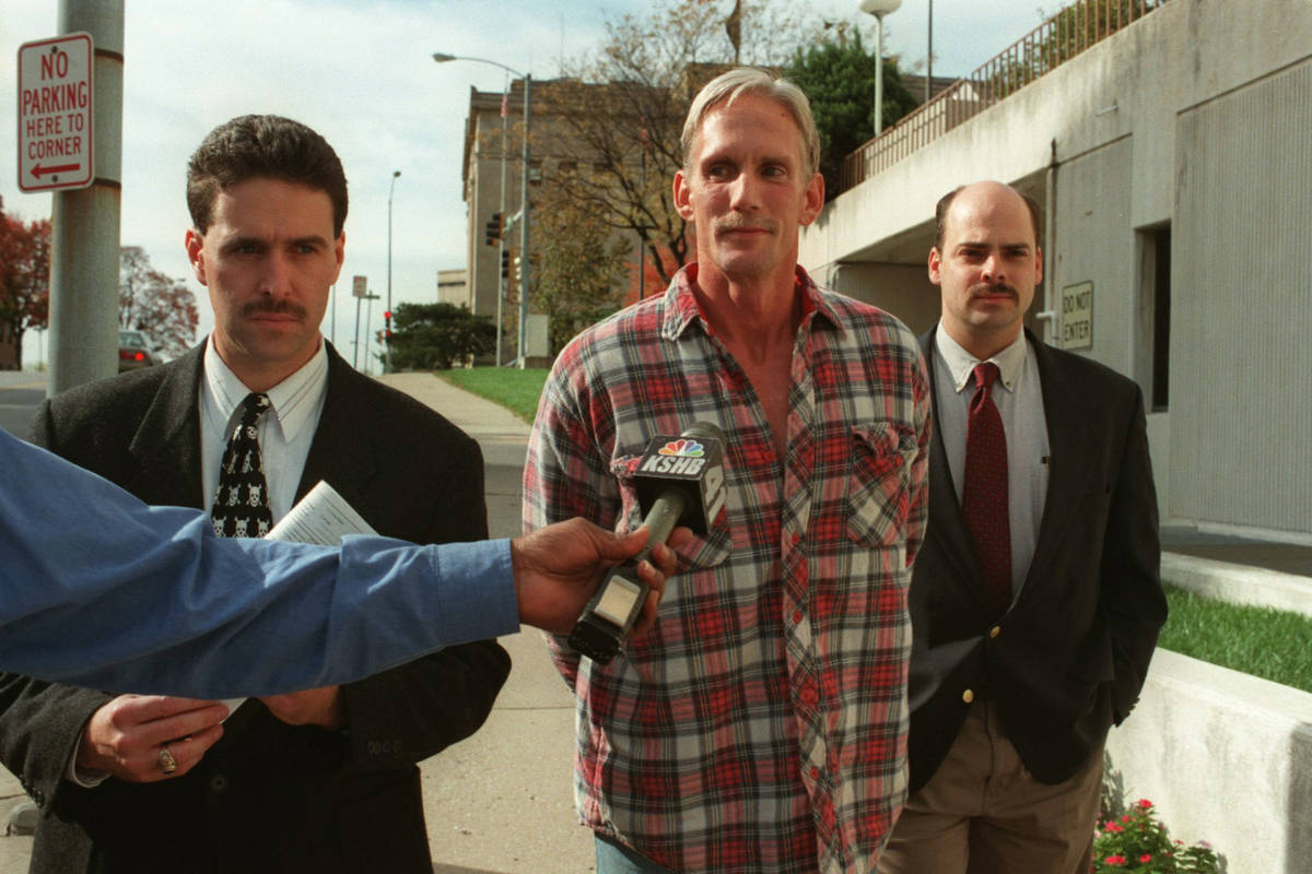 In a 1998 photo, Wesley Ira Purkey, center, is escorted by police officers in Kansas City, Kan. ...