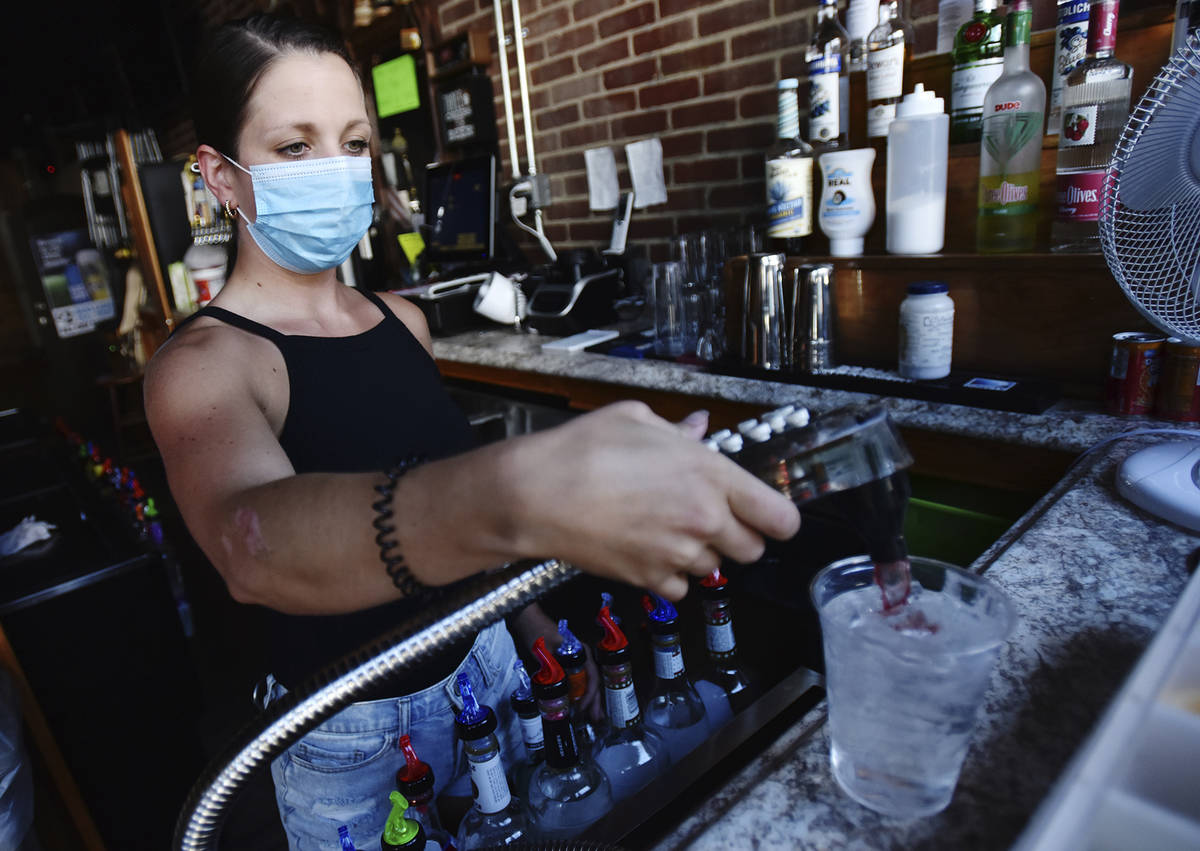 Bartender Kelsey Drozda makes a drink behind the bar at the Riverside Cafe in Wilkes-Barre, Pa. ...