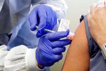 In a March 16, 2020, file photo, a subject receives a shot in the first-stage safety study clin ...