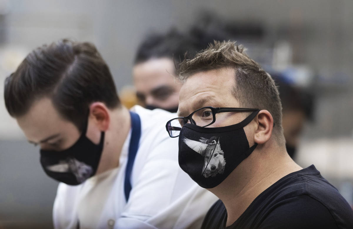 Chef/owner Brian Howard, right, works in the kitchen wearing a custom face mask at Sparrow + Wo ...