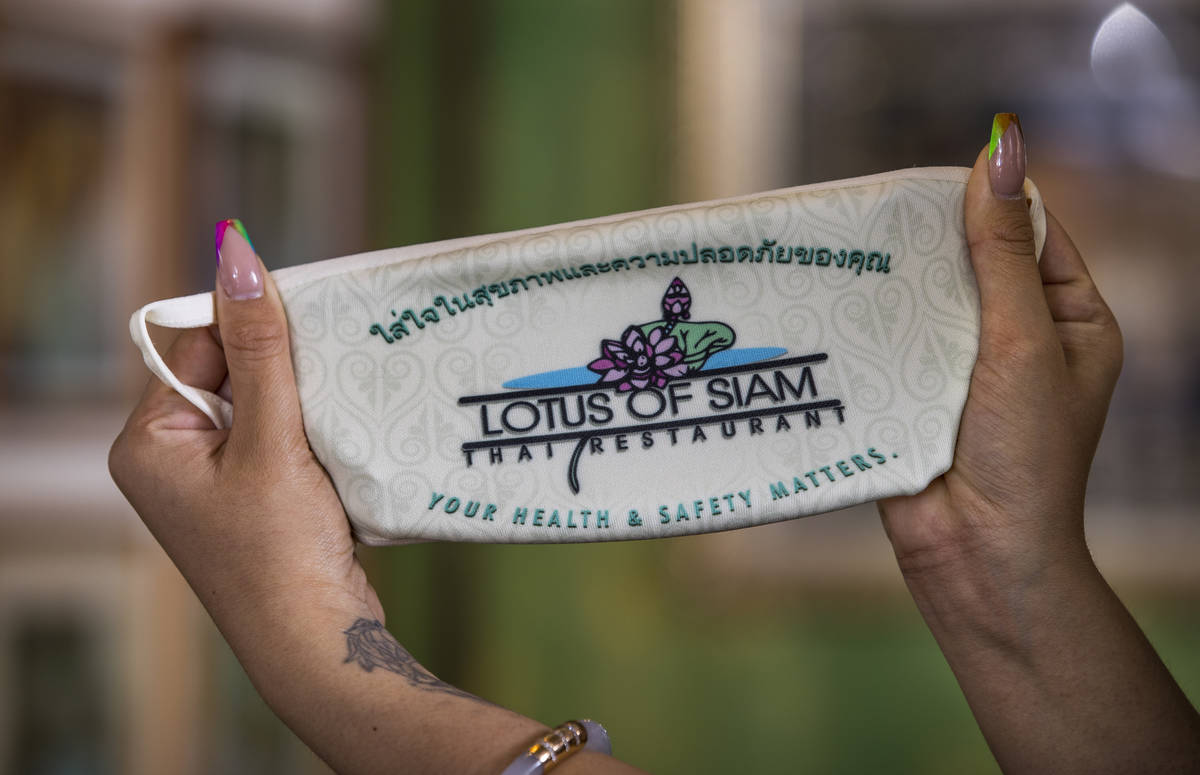 Penny Chutima at Lotus of Siam shows off a custom mask on Wednesday, July 15, 2020, in Las Vega ...