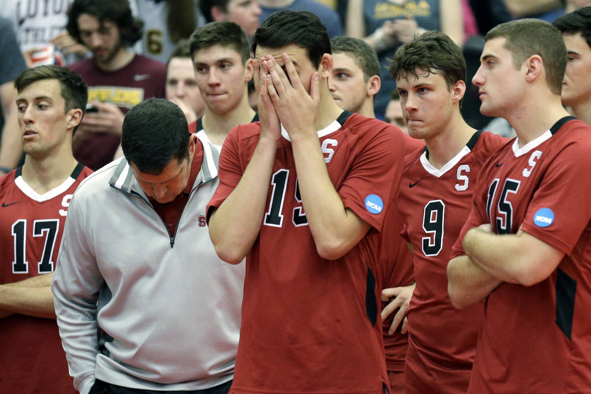 In this May 3, 2014, file photo, Stanford men's volleyball head coach John Kosty, second from l ...