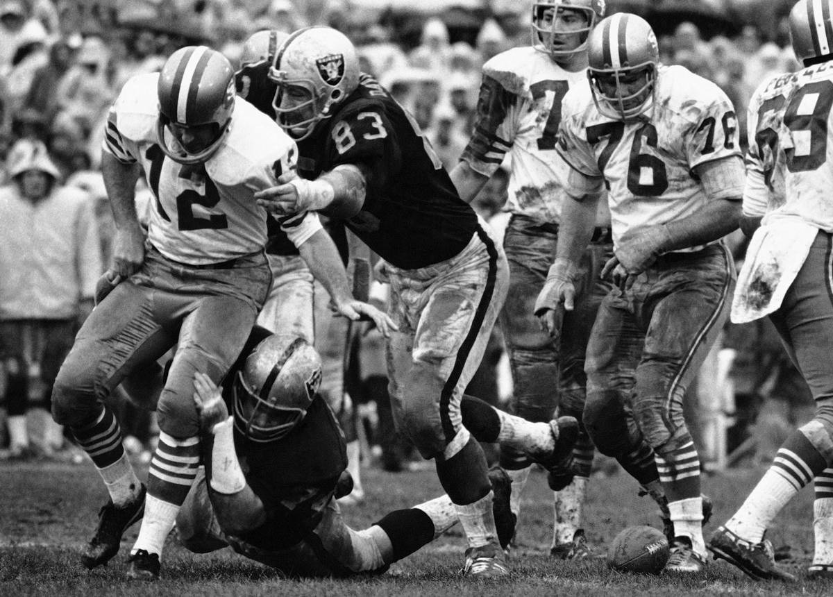 In this Dec. 20, 1970, file photo, Oakland Raiders' Ben Davidson (83) and Tom Keating, on groun ...
