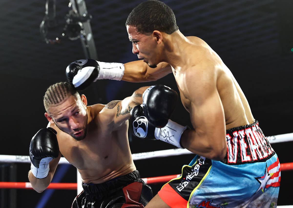 Felix Verdejo, left, lands a punch against Will Madera during their lightweight fight on Top Ra ...