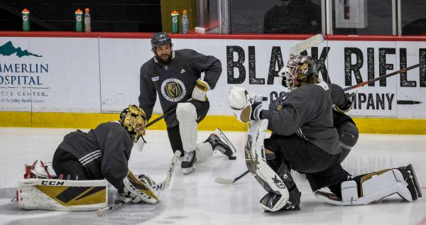 (From left) Vegas Golden Knights goaltender Marc-Andre Fleury (29), stretches with defenseman D ...
