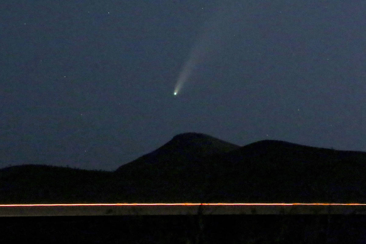 The 3-mile-wide Comet NEOWISE appears just above the horizon and Interstate 15 in the evening s ...
