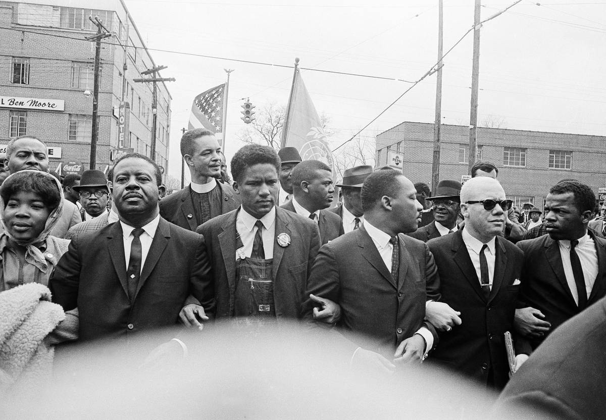 FILE - In this March 17, 1965, file photo, Dr. Martin Luther King Jr., fourth from left, foregr ...
